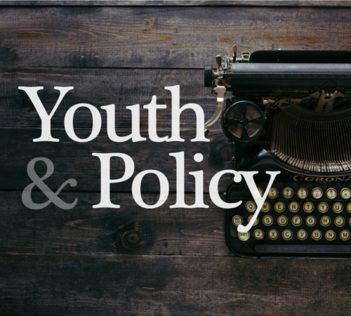 Youth and Policy logo overlayed onto a typewriter and wooden brackground